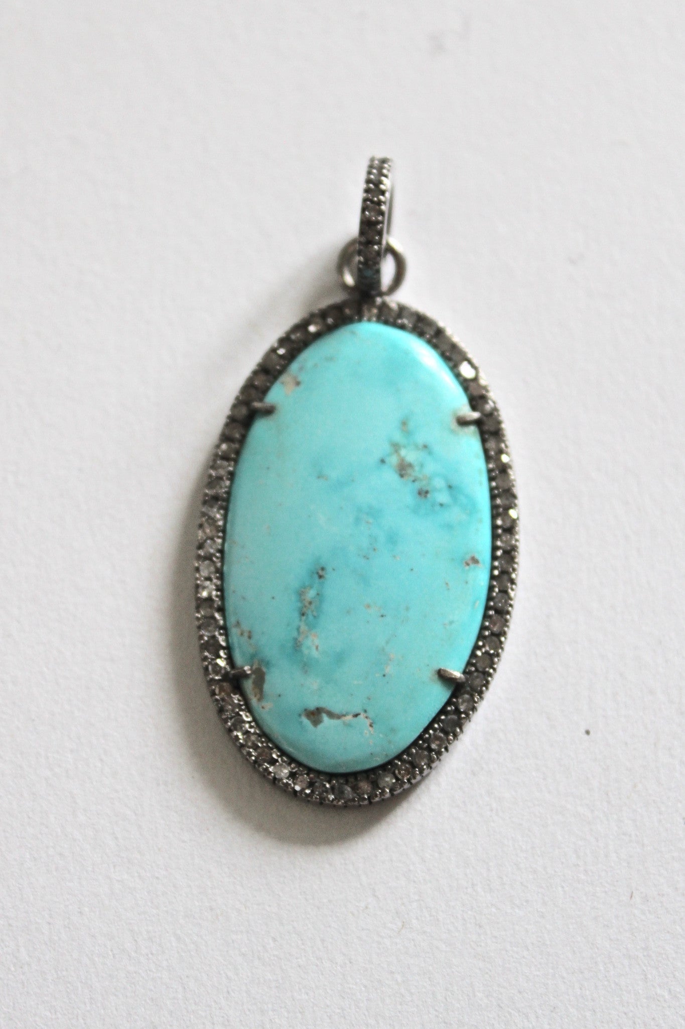 larimar pendant framed by pave diamonds