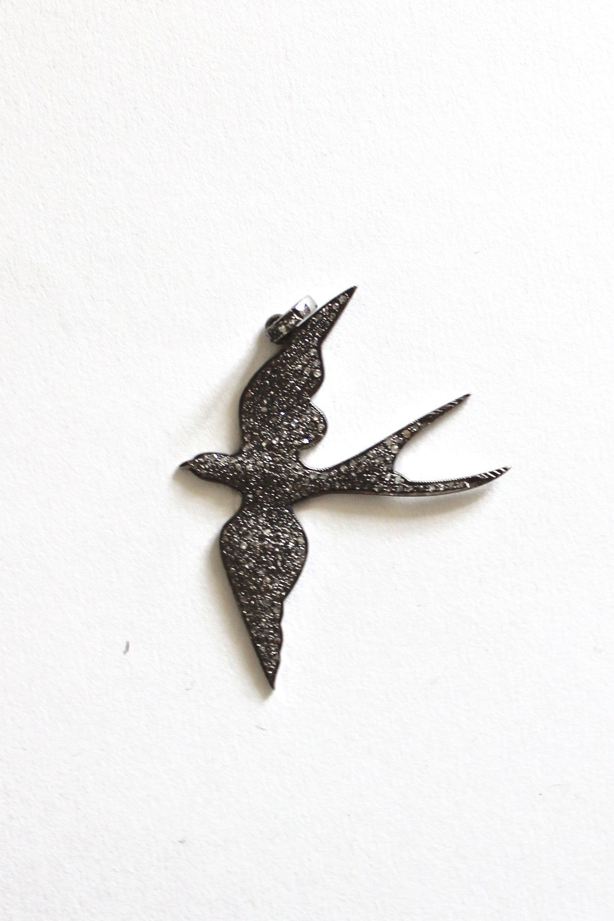 pave diamond-crusted bird pendant