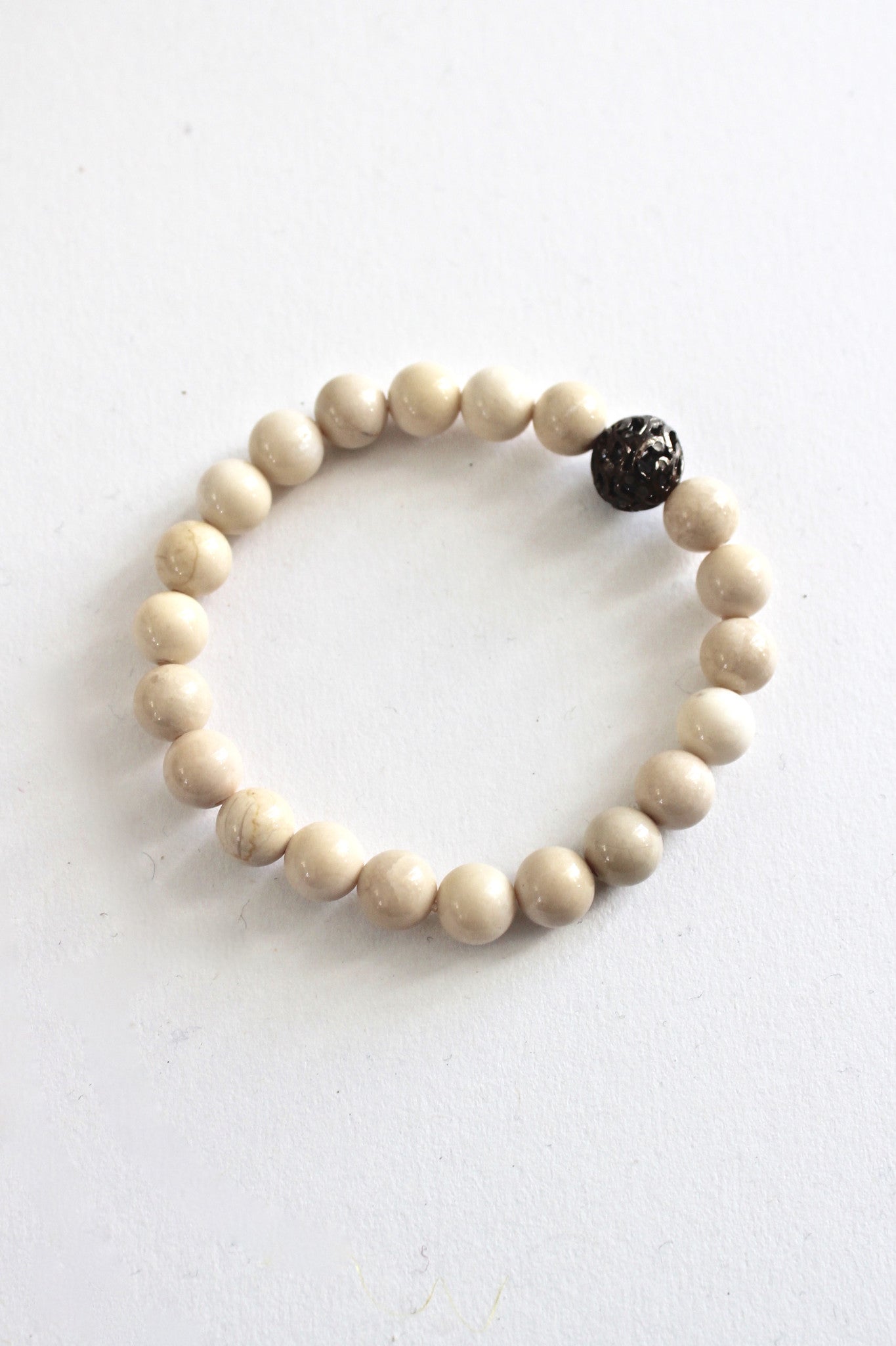 fossilized coral bracelet with small diamond bead