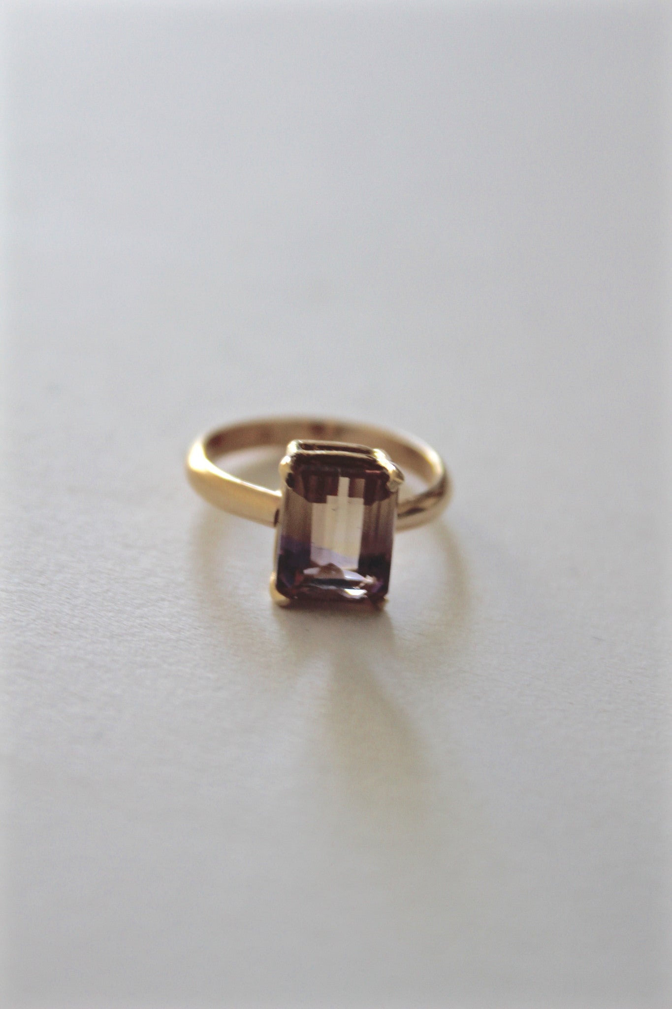emerald-cut ametrine stone set in gold